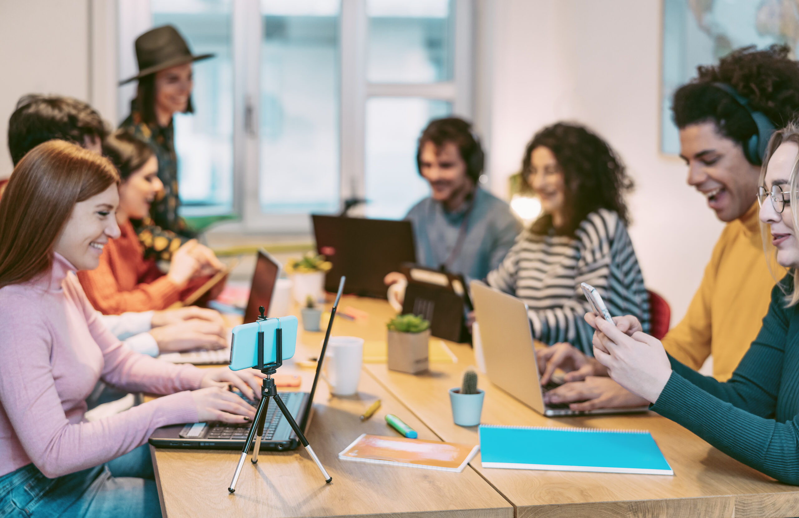 Happy young people working together inside office Multiracial